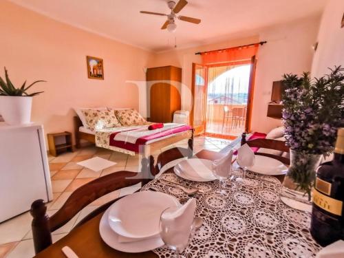 - un salon avec un canapé et une table dans l'établissement Apartments Rukelj, à Karlobag
