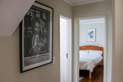 a bedroom with a bed and a picture on the wall at Traditional Portuguese Village House - Casa Martins no 52 in Freiria