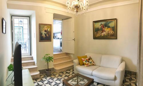 d'un salon avec un canapé blanc et un lustre. dans l'établissement Traditional Portuguese Village House - Casa Martins no 52, à Freiria