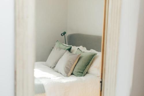 a mirror reflection of a bed with pillows on it at The Neptune in Henley on Thames