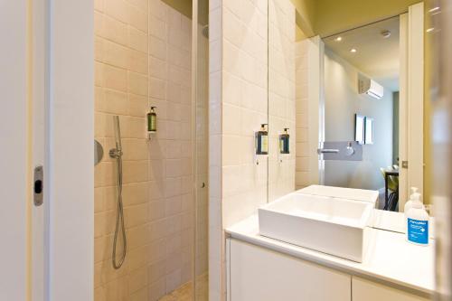 a bathroom with a sink and a shower at RVA - Porto Central Flats in Porto