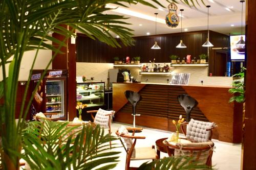 a restaurant with a bar with chairs and a counter at Aral Hotel Apartments in Tabuk