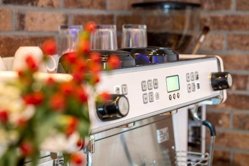 a coffee machine with wine glasses on top of it at Eurostrand Resort Lüneburger Heide in Fintel