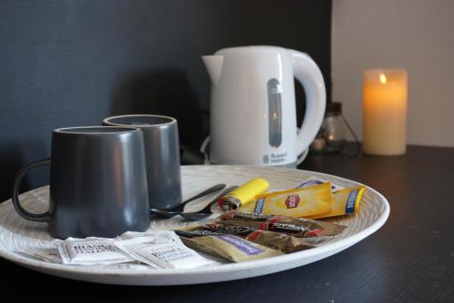 a table with a plate with a coffee mug and food at L'Alberghetto in Trinità