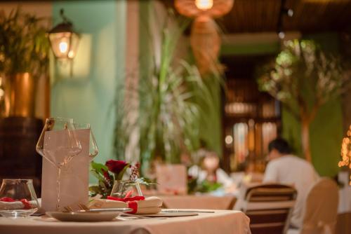 a table with a white table cloth and a wine glass at La Varangue in Antananarivo