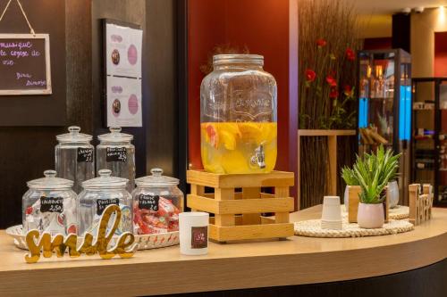 a shelf with a jar of orange juice on it at Aiden by Best Western Paris Roissy CDG in Roissy-en-France