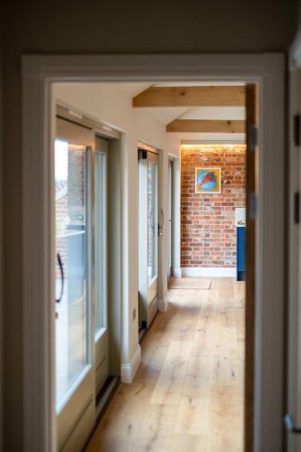 an empty hallway of a house with a brick wall at Alde Bay Farm - Oyster Catcher in Aldeburgh