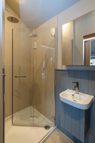 a bathroom with a shower and a sink at Alde Bay Farm - Oyster Catcher in Aldeburgh