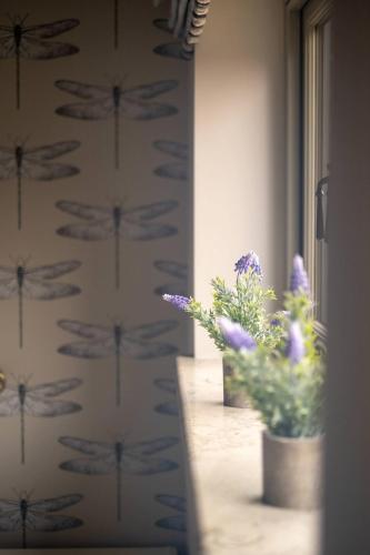 a room with a plant in a pot next to a window at Alde Bay Farm - Oyster Catcher in Aldeburgh