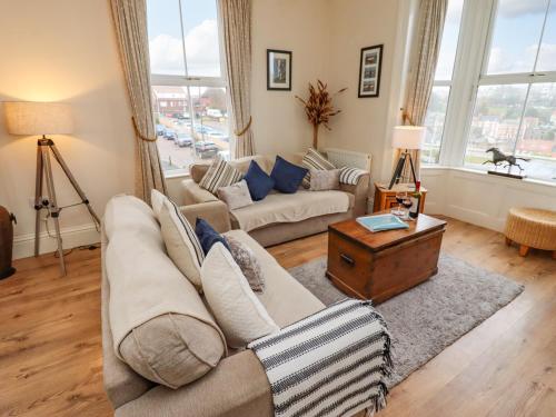 a living room with a couch and a table at White Horses in Whitby