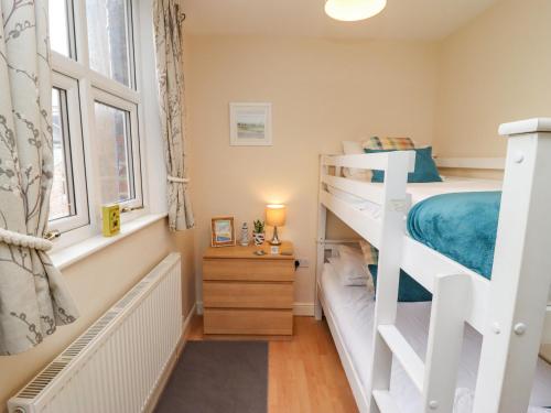 a bedroom with a bunk bed and a window at White Horses in Whitby