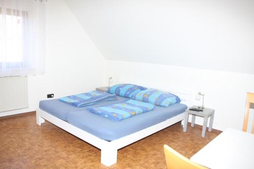a bed with blue sheets and pillows in a room at Ferienwohnung 1 Jöbstl 