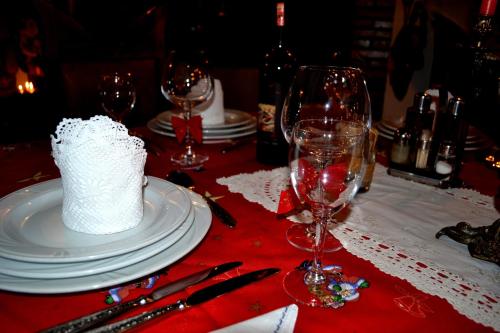 a table with wine glasses and a white cake on it at Hotel Castle Park in Berat
