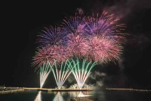 a firework display in the sky over the water at Berkshire B&B in Qimei