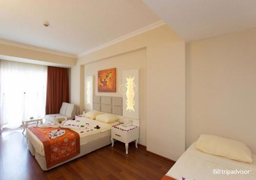 a bedroom with two beds and a window at MIRAMOR HOTEL & Spa - ULTRA ALL INCLUSIVE SELECTION in Kemer