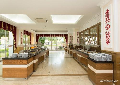 a restaurant with a buffet line with dishes at MIRAMOR HOTEL & Spa - ULTRA ALL INCLUSIVE SELECTION in Kemer