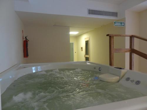 a bath tub filled with water in a room at Sul Mare Hotel in Valeria del Mar