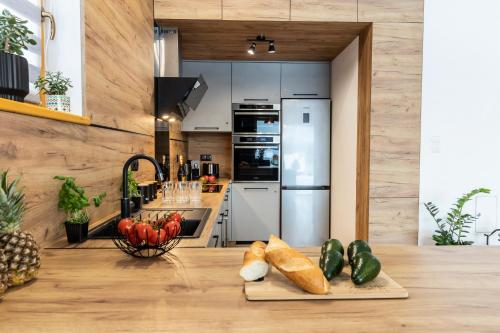 a kitchen with a counter with vegetables on a table at udanypobyt Apartamenty Czorsztyn Panorama 2 B in Czorsztyn
