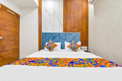 a bedroom with a bed with a colorful comforter at FabHotel Elite Inn I in Ahmedabad