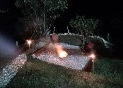 a garden at night with lights in the grass at Hospedajes el Jardin cabaña in Concepción