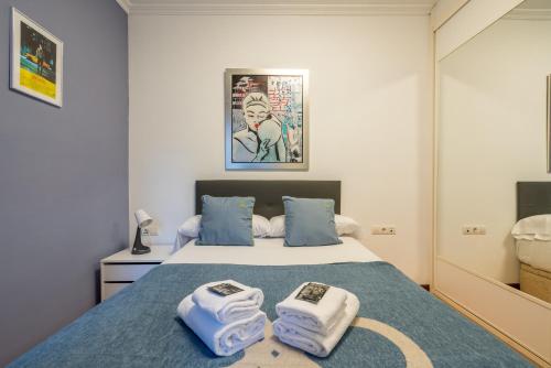 a bedroom with a bed with towels on it at Ybarra apartment by People Rentals in Bilbao