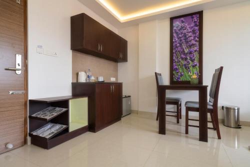 a living room with a table and a dining room at Kay Pee's Grande in Cochin