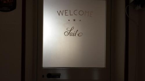 a welcome sign on a door with the words welcome wife at B&B Suite in Viagrande