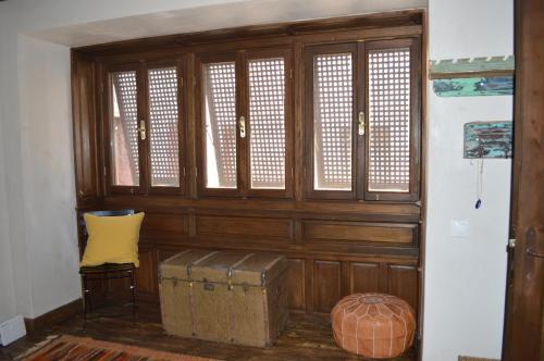 a room with a wooden wall with windows and a box at Casa Muse Kastellorizo Whole House in Meyisti