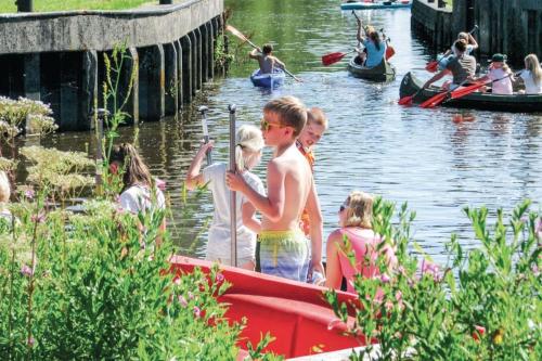 a group of children on a boat in the water at Camping 't Ol Gat in Zoutkamp