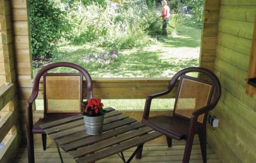 two chairs and a wooden bench on a porch at Camping 't Ol Gat in Zoutkamp