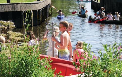 a group of children on a boat in the water at Camping 't Ol Gat in Zoutkamp