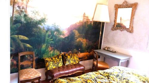 a bedroom with a large painting on the wall at Hote-Aix-Centre-garage-piscine in Aix-en-Provence