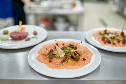 a table with three plates of food on it at Evita Hotel & SPA in Tleń