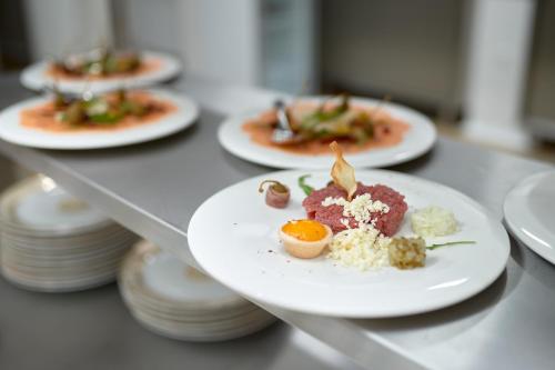 a row of plates of food on a table at Evita Hotel & SPA in Tleń