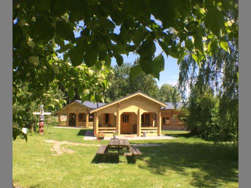 a picnic table in front of a house at Camping 't Ol Gat in Zoutkamp