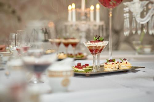 a table with a plate of food and a drink at Evita Hotel & SPA in Tleń