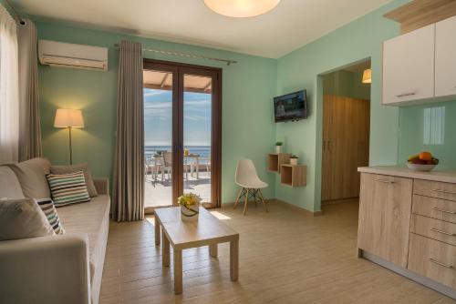 a living room with a couch and a table at Stella in the Village Suites in Plakias