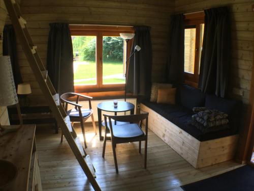 a living room with a couch and a table at Camping 't Ol Gat in Zoutkamp