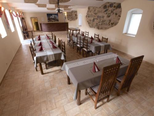 a restaurant with tables and chairs in a room at Hotel Pod Kokšínem in Spálené Poříčí