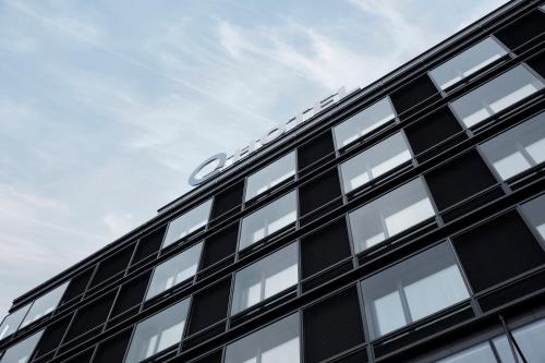 a building with a car on top of it at Q Hotel Plus Wrocław Bielany in Wrocław