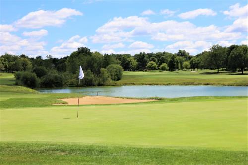 a view of a golf course with a pond at Country Inn & Suites by Radisson, Dayton South, OH in Dayton