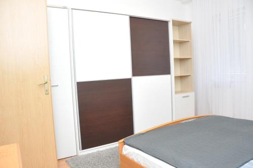 a bedroom with a sliding glass door in a room at Apartment with parking in the free garage in Sarajevo