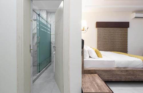 a bedroom with a bed and a mirror at BKT Cribs - Apartments & Suites in Abuja
