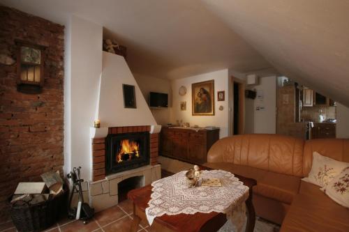a living room with a couch and a fireplace at Apartmány ReMi Vysoké Tatry in Smokovce