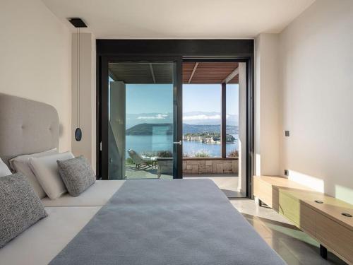 a bedroom with a bed and a view of the water at Vicky's Island View in Marathi