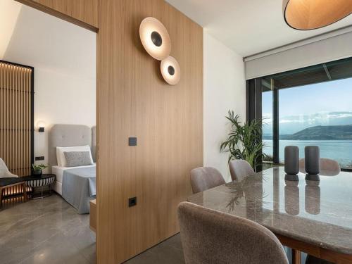 a dining room with a table and a bedroom at Vicky's Island View in Marathi