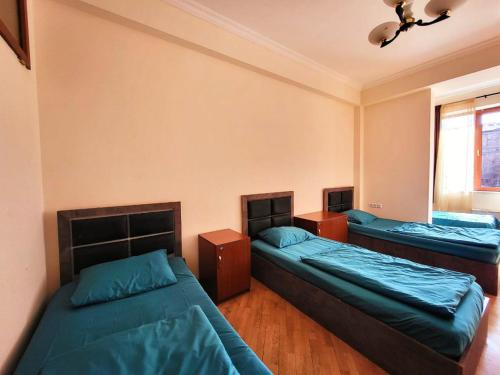 a bedroom with two beds and a window at ArevaHostel&Apartment in Yerevan