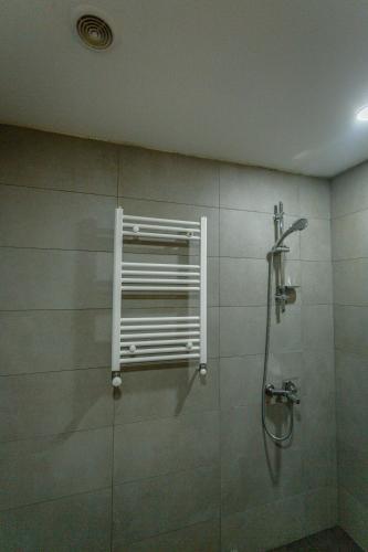 a bathroom with a shower with a window at Didveli Gallery B-110 in Bakuriani