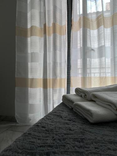 a pile of towels sitting on a rug in front of a window at B&B Dei Vicari in Frattamaggiore