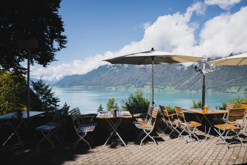 a table and chairs with a view of a lake at Grandhotel Giessbach in Brienz